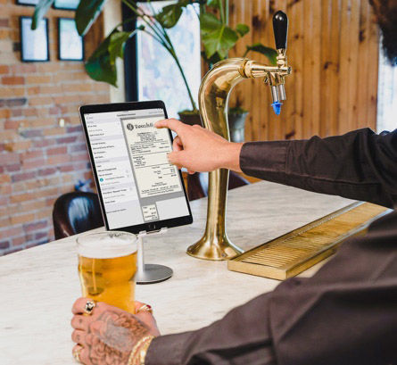 Customer checking his bill on the TouchBistro software after purchasing a beer