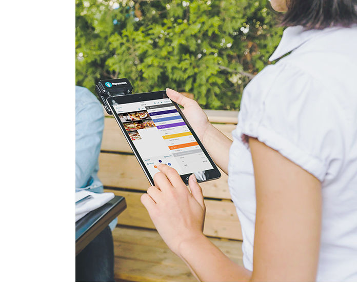 Restaurant employee on iPad using Touchbistro software