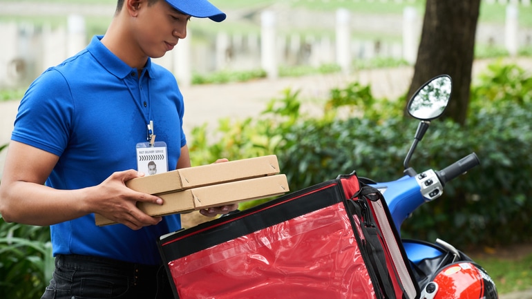A food courier delivering pizzas
