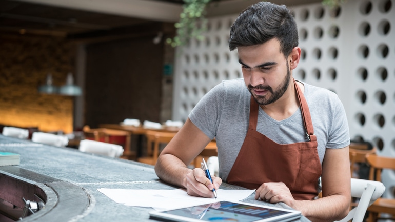 Restaurant working using a tablet to do the finances